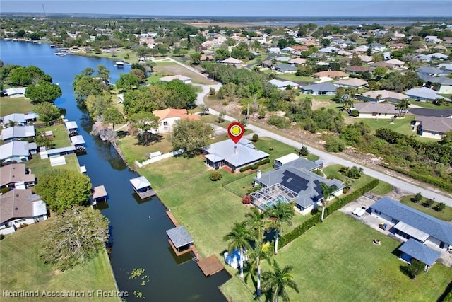 drone / aerial view featuring a water view and a residential view