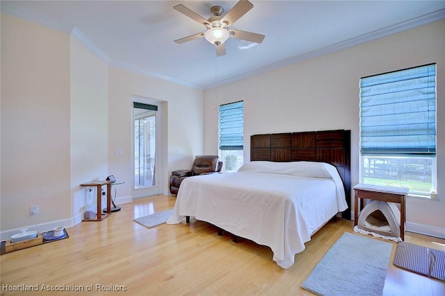 bedroom featuring light wood-type flooring, baseboards, ornamental molding, and ceiling fan