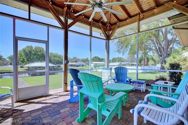 unfurnished sunroom featuring wooden ceiling and ceiling fan