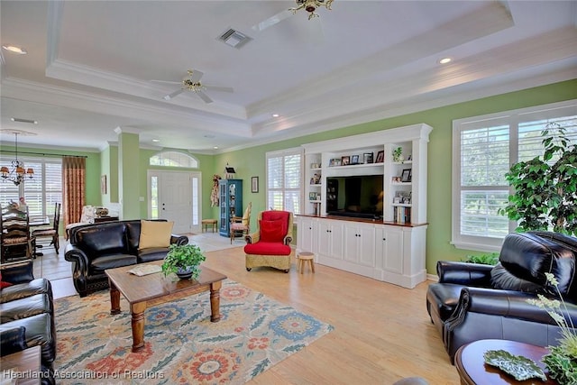 3421 E Glen Eagles Dr, Avon Park, FL 33825 - living room with a raised ceiling, ceiling fan, ornamental molding, and light wood-style flooring
