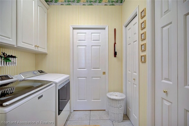 3421 E Glen Eagles Dr, Avon Park, FL 33825 - laundry area featuring washing machine and clothes dryer, cabinet space, light tile patterned floors, and wallpapered walls