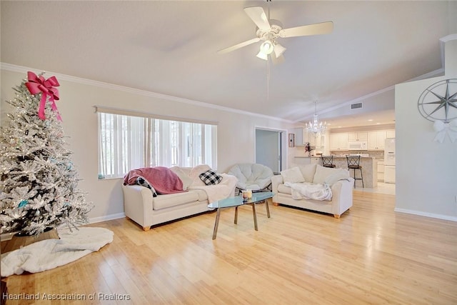 living room with ceiling fan with notable chandelier, light hardwood / wood-style floors, crown molding, and lofted ceiling