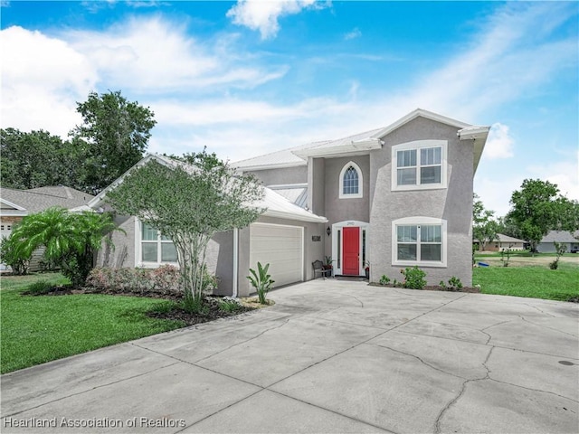 2910 Fairway Ln, Bowling Green, FL 33834 - view of front of property featuring a garage, stucco siding, driveway, and a front yard