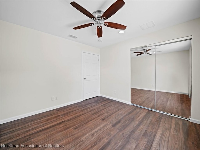 unfurnished bedroom with a closet, ceiling fan, and dark hardwood / wood-style floors