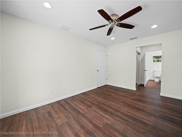 empty room with ceiling fan and dark wood-type flooring