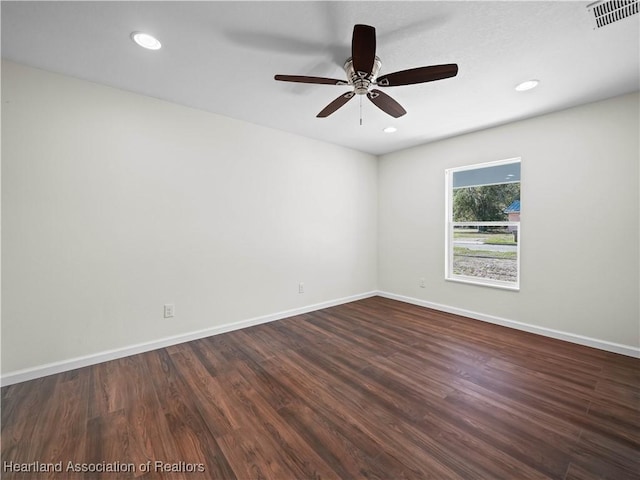 spare room with dark hardwood / wood-style floors and ceiling fan