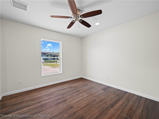 unfurnished room with ceiling fan and dark hardwood / wood-style flooring