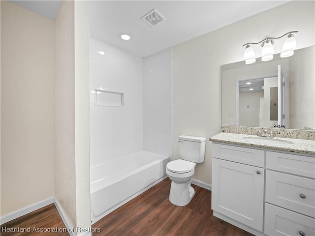 full bathroom with hardwood / wood-style floors, vanity, toilet, and shower / bathing tub combination