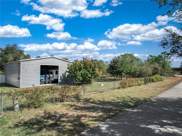 view of yard featuring a garage and an outdoor structure