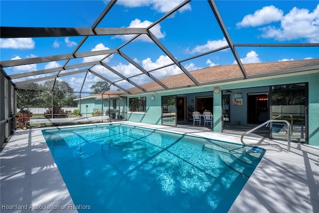 view of swimming pool with a lanai and a patio