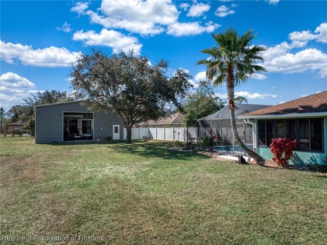 view of yard featuring a fenced in pool and a lanai