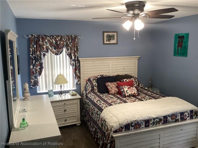 bedroom featuring ceiling fan and dark hardwood / wood-style flooring