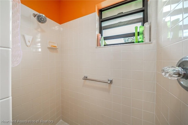 bathroom with a tile shower