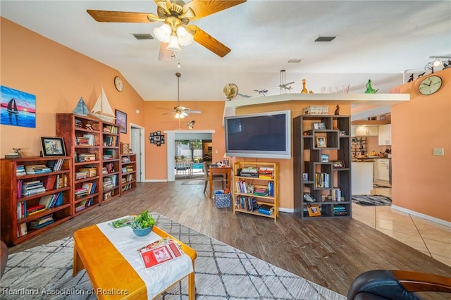 living room featuring wood-type flooring and ceiling fan