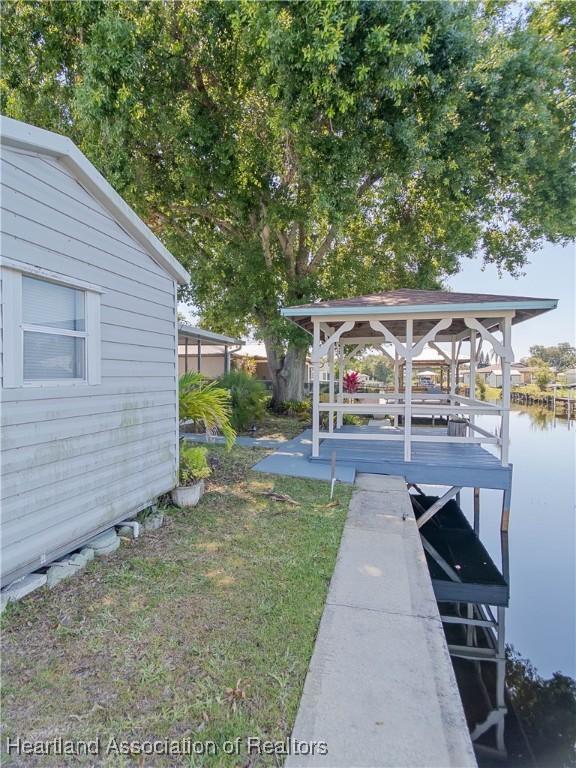 956 Shamrock Dr, Sebring, FL 33875 - dock area with a water view and a yard
