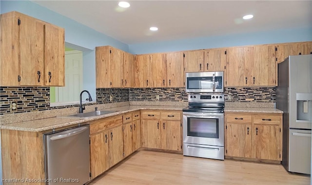 956 Shamrock Dr, Sebring, FL 33875 - kitchen with stainless steel appliances, a sink, decorative backsplash, light wood-style flooring, and recessed lighting