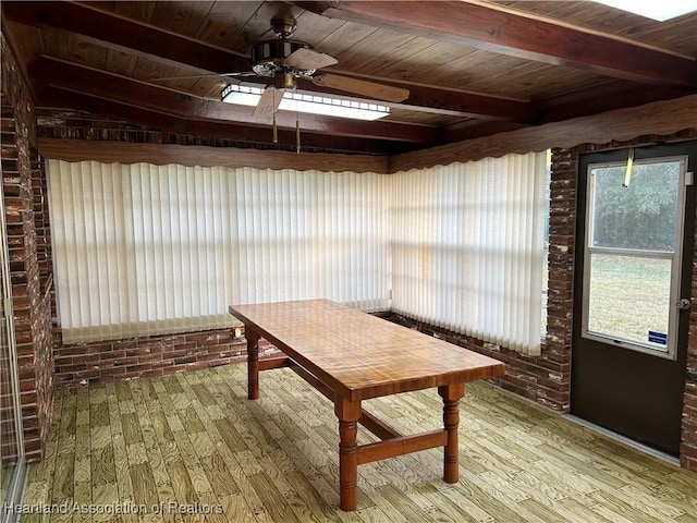 unfurnished sunroom with ceiling fan, beamed ceiling, and wood ceiling