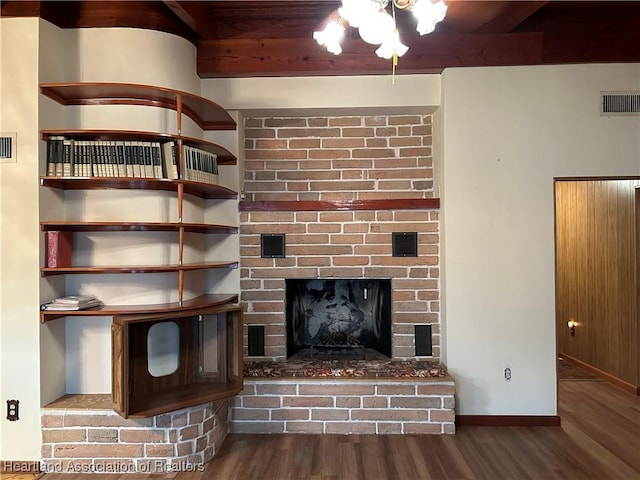 room details featuring hardwood / wood-style flooring, a fireplace, and beamed ceiling