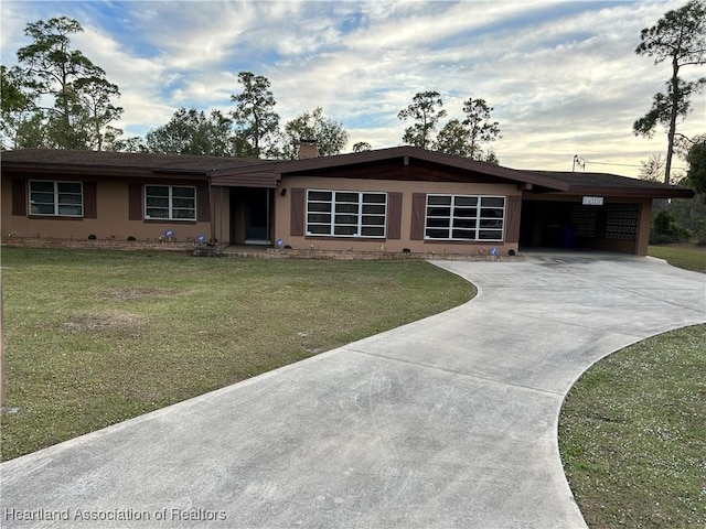 3505 Golfview Rd, Sebring, FL 33875 - ranch-style house with a carport and a lawn