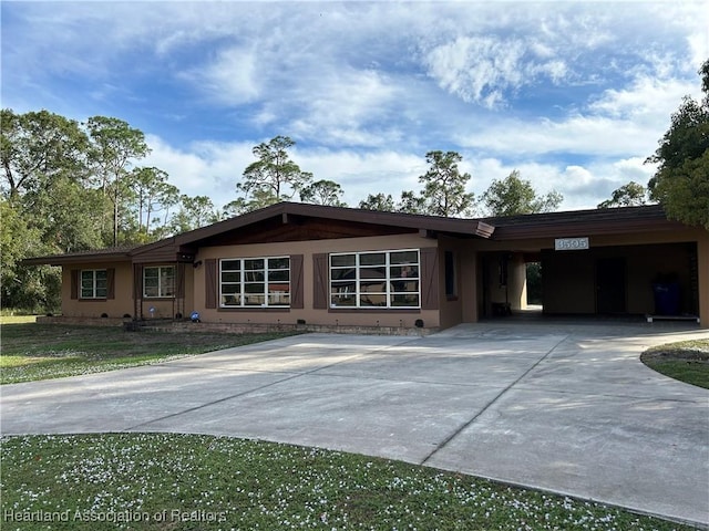 ranch-style home featuring a carport