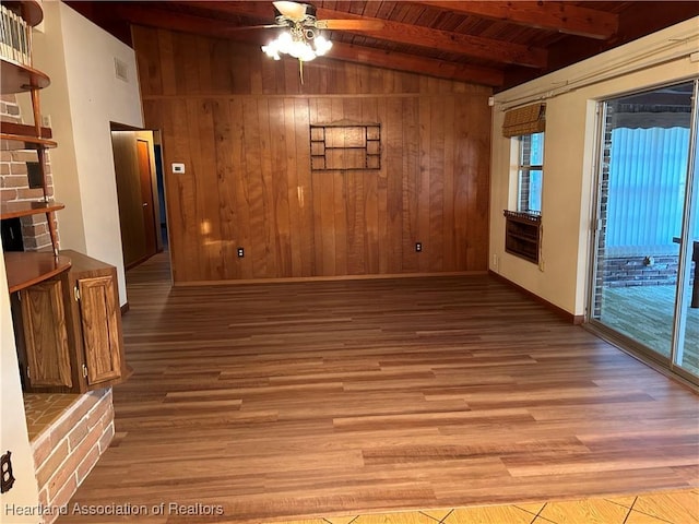 empty room featuring ceiling fan, wooden ceiling, vaulted ceiling with beams, light hardwood / wood-style flooring, and wooden walls