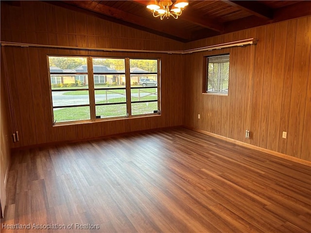 unfurnished room with an inviting chandelier, vaulted ceiling with beams, hardwood / wood-style floors, wooden walls, and wood ceiling