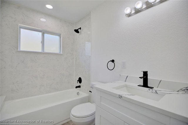 bathroom with vanity, toilet, and bathing tub / shower combination