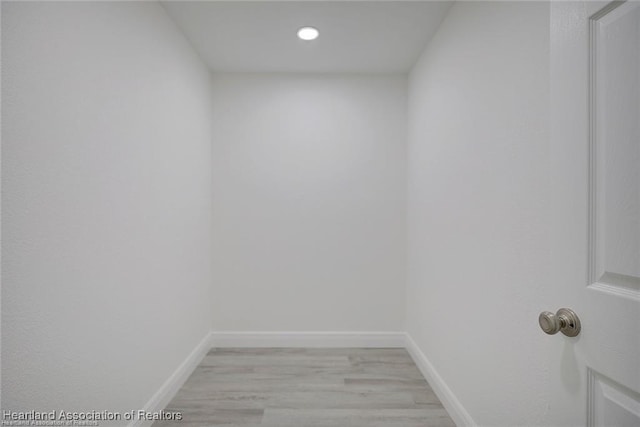 interior space featuring light wood finished floors and baseboards