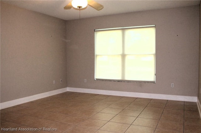 unfurnished room with tile patterned floors and ceiling fan