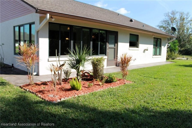 rear view of house with a yard