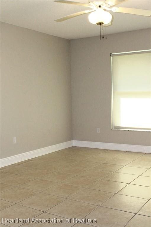 tiled empty room with ceiling fan