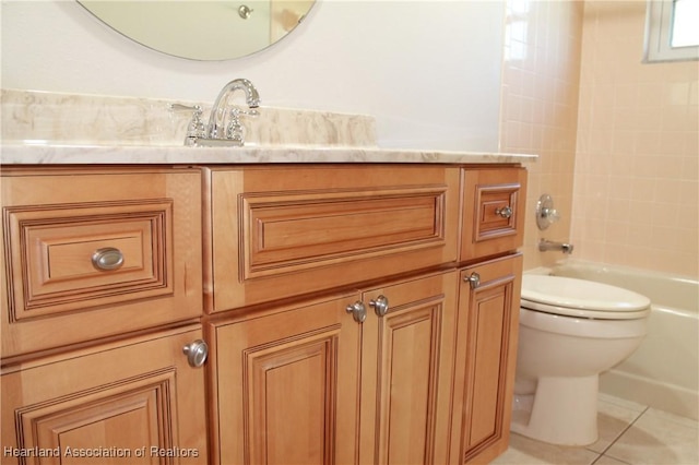 bathroom with tile patterned floors, tiled shower / bath combo, and toilet