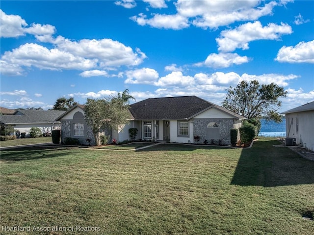 ranch-style home with a front lawn and central AC unit