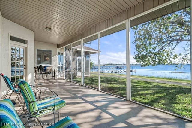 unfurnished sunroom with a water view and a healthy amount of sunlight