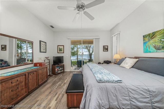 bedroom with access to outside, ceiling fan, and light hardwood / wood-style floors