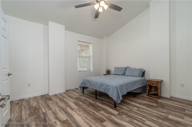 bedroom featuring hardwood / wood-style flooring, vaulted ceiling, and ceiling fan