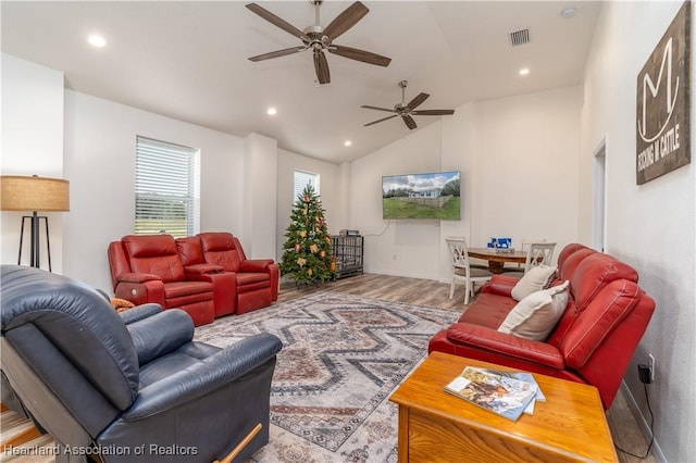 living room featuring wood-type flooring, vaulted ceiling, and ceiling fan