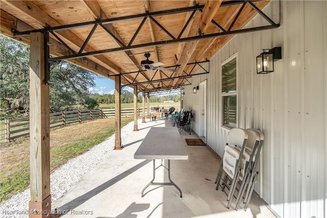 view of patio / terrace featuring a rural view and ceiling fan