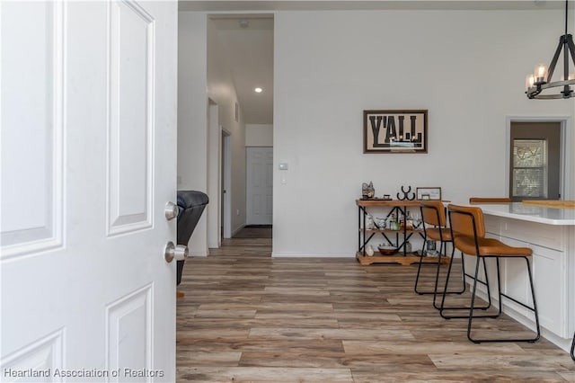 dining area with a notable chandelier and light hardwood / wood-style flooring