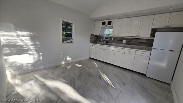 1022 Marble Ave, Avon Park, FL 33825 - kitchen featuring dark countertops, marble finish floor, white cabinets, and freestanding refrigerator