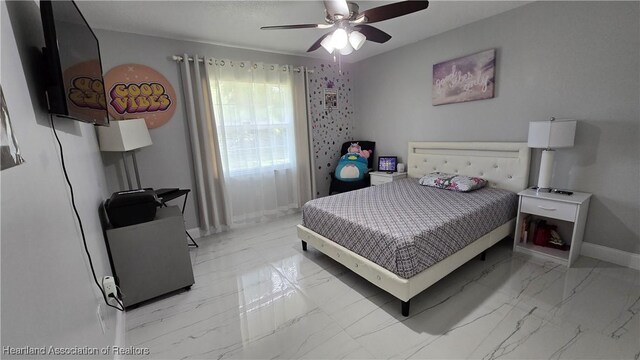 1022 Marble Ave, Avon Park, FL 33825 - bedroom with ceiling fan, marble finish floor, and baseboards