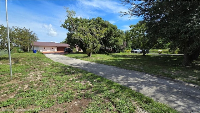 1022 Marble Ave, Avon Park, FL 33825 - view of front of house with driveway, a garage, and a front lawn