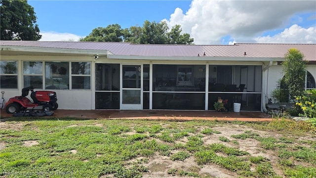 1022 Marble Ave, Avon Park, FL 33825 - rear view of property with a yard, a sunroom, and metal roof