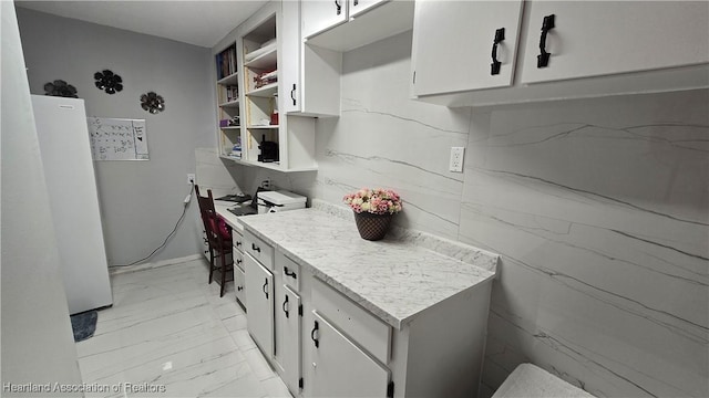 1022 Marble Ave, Avon Park, FL 33825 - kitchen featuring marble finish floor, light countertops, open shelves, and white cabinets