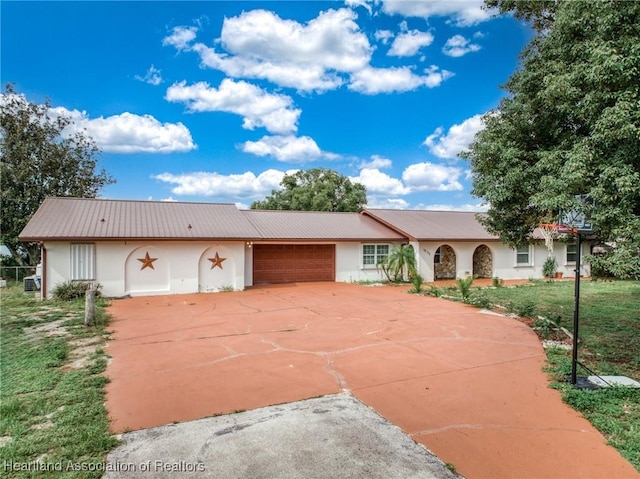 1022 Marble Ave, Avon Park, FL 33825 - single story home featuring a garage, metal roof, concrete driveway, and stucco siding