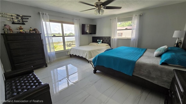 1022 Marble Ave, Avon Park, FL 33825 - bedroom featuring a textured ceiling, marble finish floor, multiple windows, and ceiling fan