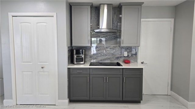 1022 Marble Ave, Avon Park, FL 33825 - kitchen featuring wall chimney range hood, black electric cooktop, gray cabinets, and light countertops