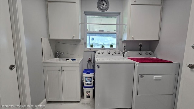1022 Marble Ave, Avon Park, FL 33825 - laundry area with washing machine and dryer, cabinet space, and a sink