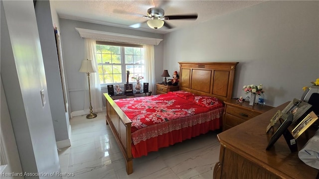 1022 Marble Ave, Avon Park, FL 33825 - bedroom featuring a ceiling fan, marble finish floor, and a textured ceiling