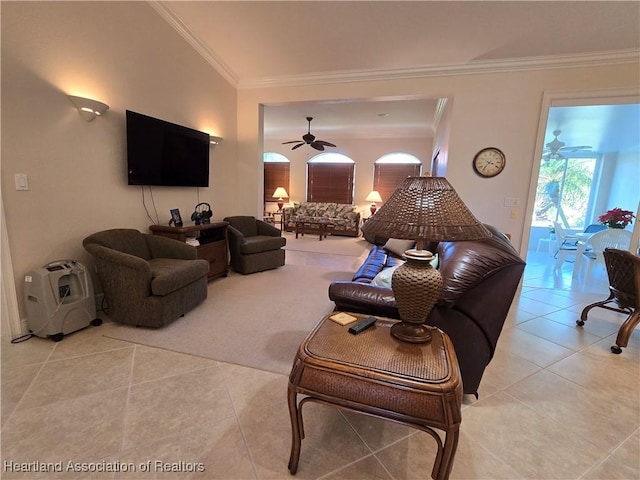 tiled living room featuring ceiling fan and ornamental molding